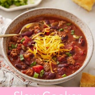 Pinterest graphic of a bowl of slow cooker chili with shredded cheese on top with a spoon tucked into the chili.