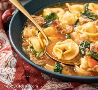 Pinterest graphic of a side view of half a bowl of tortellini soup with a golden soup tucked under a tortellini.