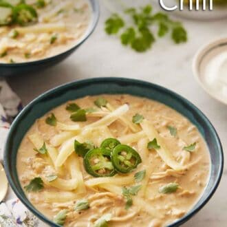 Pinterest graphic of two bowls of white chicken chili with the second bowl out of focus in the background.