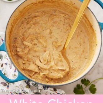 Pinterest graphic of a pot of white chicken chili with a gold colored ladle inside.