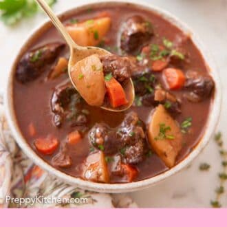 Pinterest graphic of a bowl of beef stew with a spoonful lifted up in front.