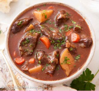 Pinterest graphic of a bowl of beef stew with bread, fresh thyme, water, a spoon, and parsley around it.
