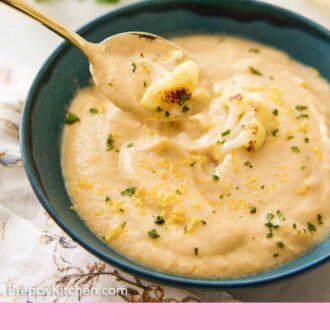 Pinterest graphic of a bowl of cauliflower soup with a spoonful lifted out.
