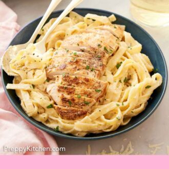 Pinterest graphic of a bowl of chicken alfredo with a spoon and fork tucked into the noodles.