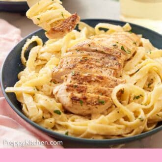 Pinterest graphic of a fork with alfredo noodles swirled around it and a piece of chicken on the end, lifted from a plate of chicken alfredo.