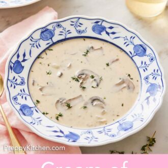 Pinterest graphic of a bowl of cream of mushroom soup with a glass of wine and a second bowl of soup in the background.