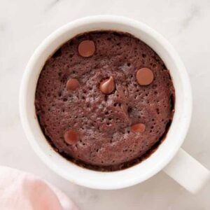 Overhead view of a mug cake with chocolate chips.