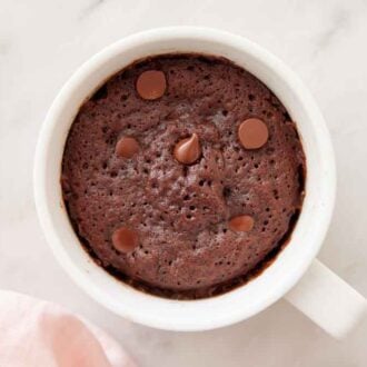 Overhead view of a mug cake with chocolate chips.