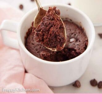 Pinterest graphic of a mug cake with a spoonful lifted out of the mug.