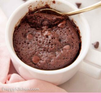 Pinterest graphic of a mug cake with a spoon tucked in.