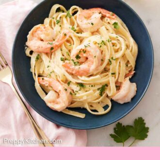 Pinterest graphic of an overhead view of a plate of shrimp Alfredo with a glass of wine off to the side.