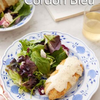 Pinterest graphic of a plate of chicken cordon bleu with salad on the side.