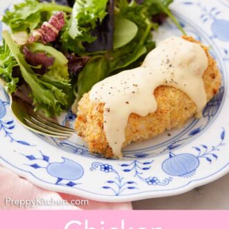 Pinterest graphic of a plate of chicken cordon bleu topped with sauce with some salad on the side.