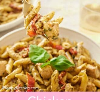 Pinterest graphic of a fork lifting up a bite of chicken pesto pasta from a plate.