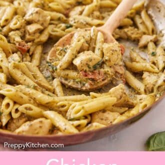 Pinterest graphic of a skillet of chicken pesto pasta with a wooden spoon inside.