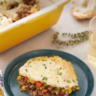Pinterest graphic of a plate of shepherd's pie with a baking dish in the back with the rest of the meal.