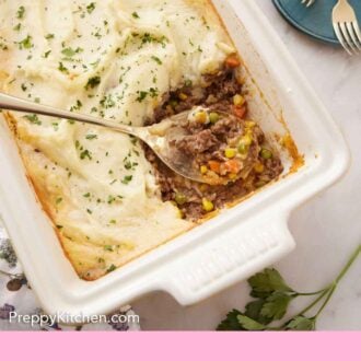Pinterest graphic of an overhead view of a baking with with shepherd's pie with a spoonful scooped out.