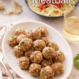 Pinterest graphic of a platter of turkey meatballs with a glass of wine and a bowl of noodles and sauce in the back.