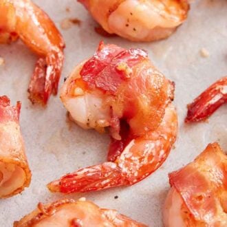 Close up overhead view of bacon wrapped shrimp in a single layer.