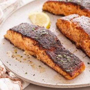 A close view of a platter with blackened salmon.