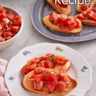Pinterest graphic of a plate with two pieces of bruschetta with a platter with more in the background.