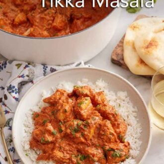 Pinterest graphic of a bowl of rice with chicken tikka masala on top with more in a pot in the background.