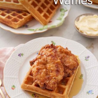 Pinterest graphic of a plate of chicken and waffles with a pile of waffles in the background and butter on the side.