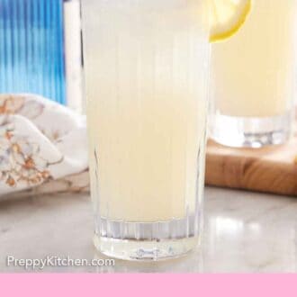 Pinterest graphic of a glass of Gin Fizz with a lemon slice garnish on the rim.