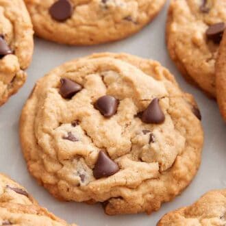Multiple peanut butter chocolate chip cookies with the focus on one in the middle.