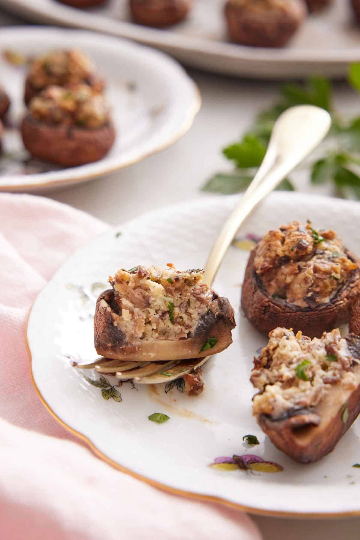 A close up view of a stuffed mushroom on top of a fork.