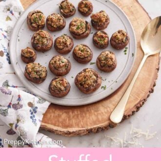 Pinterest graphic of a wooden serving block with a round platter of stuffed mushrooms on top and a large serving spoon beside the platter.