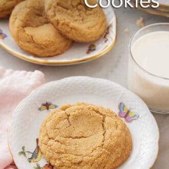 Pinterest graphic of a plate with a brown sugar cookie with a glass of milk and platter of cookies in the back.