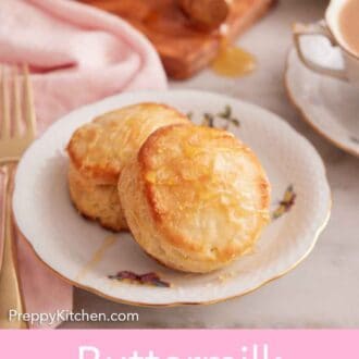 Pinterest graphic of two buttermilk biscuits on a plate with honey and coffee in the background.