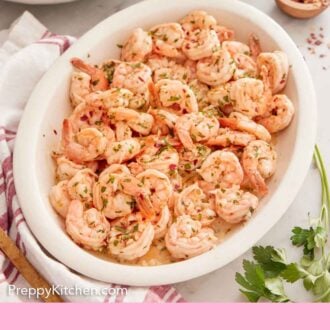 Pinterest graphic of an oval platter of garlic shrimp with some rice and red pepper flakes in the background.