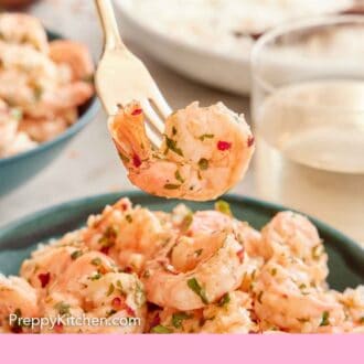 Pinterest graphic of a fork lifting up a garlic shrimp from a bowl.