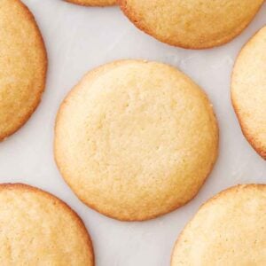 Overhead view of honey cookies in a single layer.