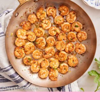 Pinterest graphic of an overhead view of a skillet of sautéed shrimp.
