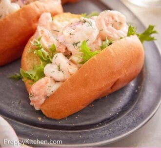 Pinterest graphic of shrimp salad served over some greens in a bun.