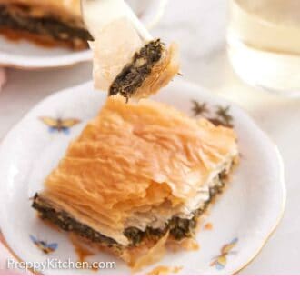 Pinterest graphic of a forkful of spanakopita lifted from a plate.