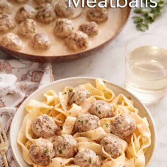 Pinterest graphic of a plate of noodles with Swedish meatballs on top and a skillet in the back.