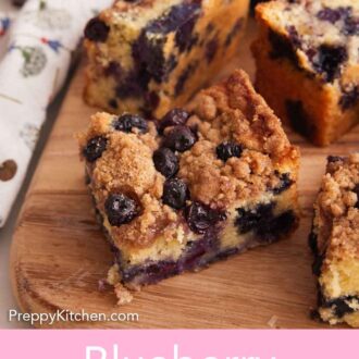 Pinterest graphic of multiple pieces of cut blueberry buckle on a cutting board with a bowl of blueberries in the background.