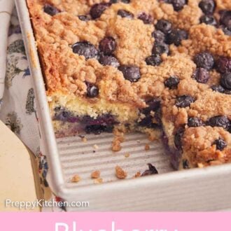 Pinterest graphic of an angled view of a blueberry buckle in its baking pan with a square piece removed.