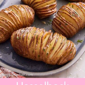Pinterest graphic of a platter of hasselback potatoes with chopped parsley on top.