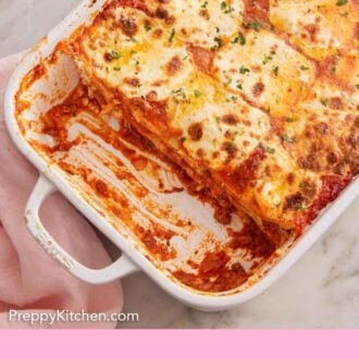 Pinterest graphic of an overhead view of a baking dish of lasagna with a few portions removed.
