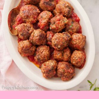 Pinterest graphic of an overhead view of an oval platter of meatballs tossed in sauce.