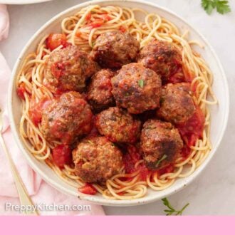 Pinterest graphic of an overhead view of a bowl of noodles with meatballs tossed in tomato sauce.