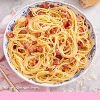 Pinterest graphic of a bowl of pasta carbonara with some torn bread and stacked plates in the background.