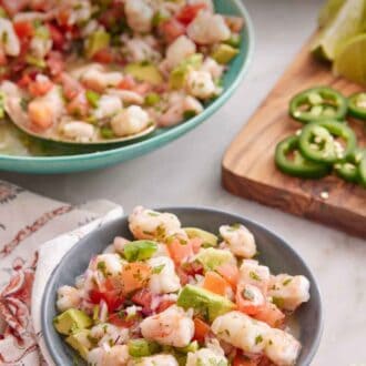 Pinterest graphic of a small bowl of shrimp ceviche with a platter in the background along with cut jalapeno and limes.