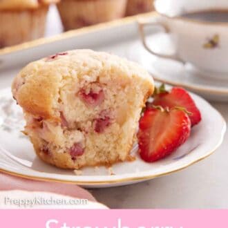 Pinterest graphic of a plate with a strawberry muffin with a bite taken out of it with a cut strawberry beside it.