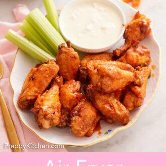 Pinterest graphic of a platter with multiple air fryer chicken wings with dip and celery sticks.